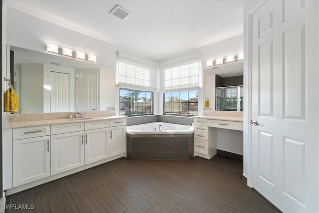 bathroom with vanity and independent shower and bath