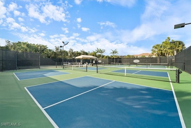 view of tennis court featuring basketball hoop