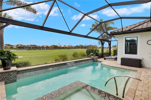 view of pool with glass enclosure and a patio area