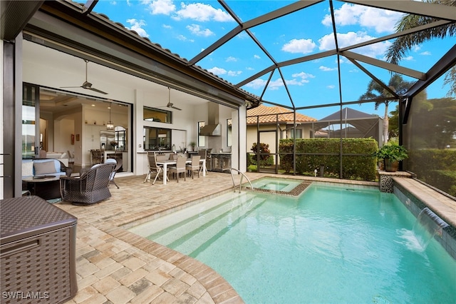 view of pool with outdoor lounge area, pool water feature, ceiling fan, an in ground hot tub, and a patio area