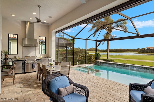 view of swimming pool with grilling area, a water view, a lanai, exterior kitchen, and a patio