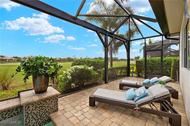 view of patio featuring glass enclosure