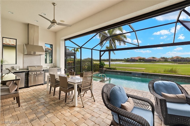 exterior space with glass enclosure, ceiling fan, a grill, exterior kitchen, and a patio