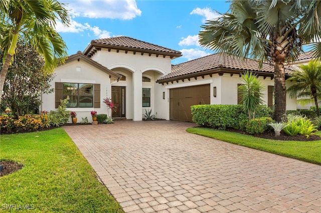 mediterranean / spanish home with a garage