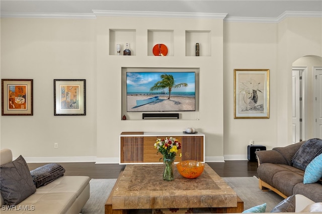 living room with hardwood / wood-style flooring, built in shelves, and ornamental molding