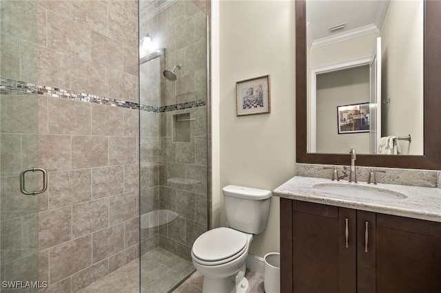 bathroom with toilet, vanity, an enclosed shower, and ornamental molding