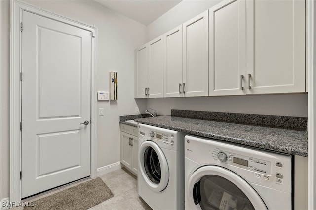 washroom featuring cabinets, light tile patterned floors, sink, and washing machine and clothes dryer