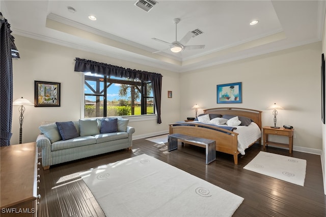 bedroom featuring a tray ceiling, ceiling fan, and dark wood-type flooring