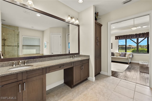 bathroom featuring tile patterned floors, vanity, ceiling fan, and walk in shower