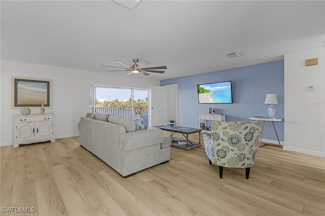 living room with light wood-type flooring and ceiling fan