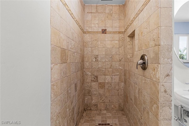 bathroom with tiled shower