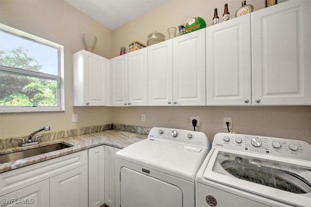 laundry area with cabinets, sink, and washer and dryer