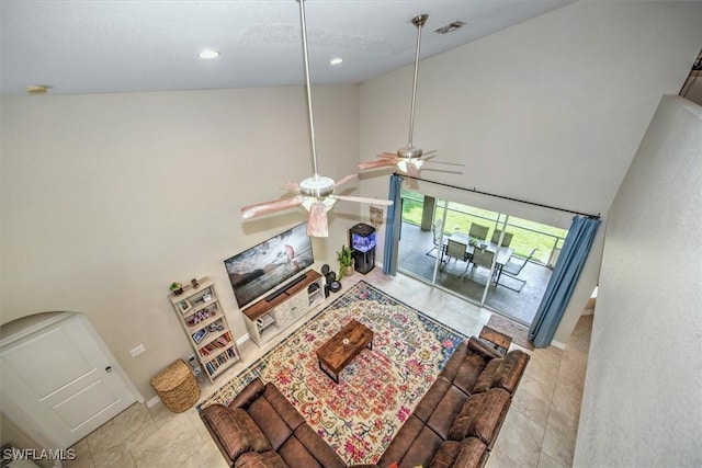 tiled living room featuring high vaulted ceiling and ceiling fan