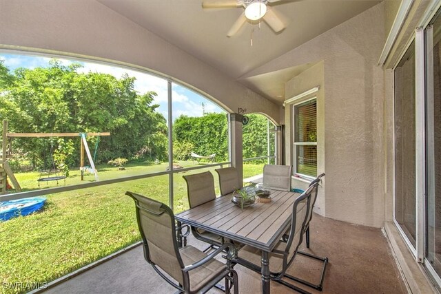 sunroom with lofted ceiling and ceiling fan