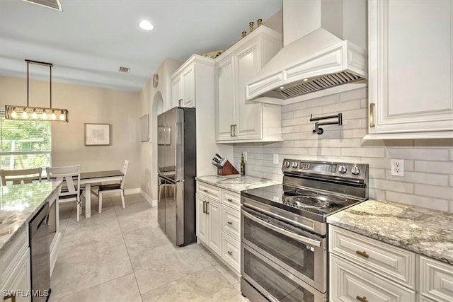 kitchen with white cabinetry, custom exhaust hood, light stone countertops, and appliances with stainless steel finishes