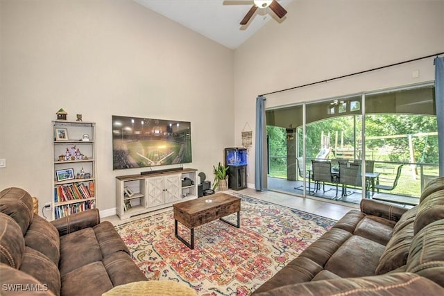 tiled living room featuring ceiling fan and high vaulted ceiling