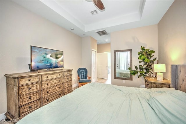 bedroom featuring ceiling fan and a tray ceiling