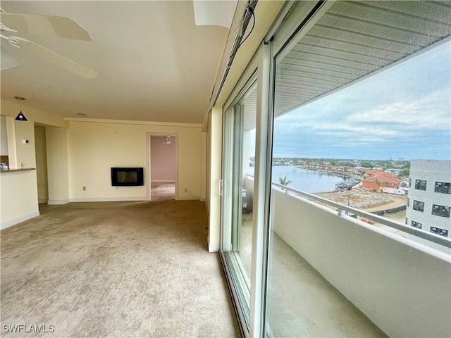 balcony featuring a water view and heating unit