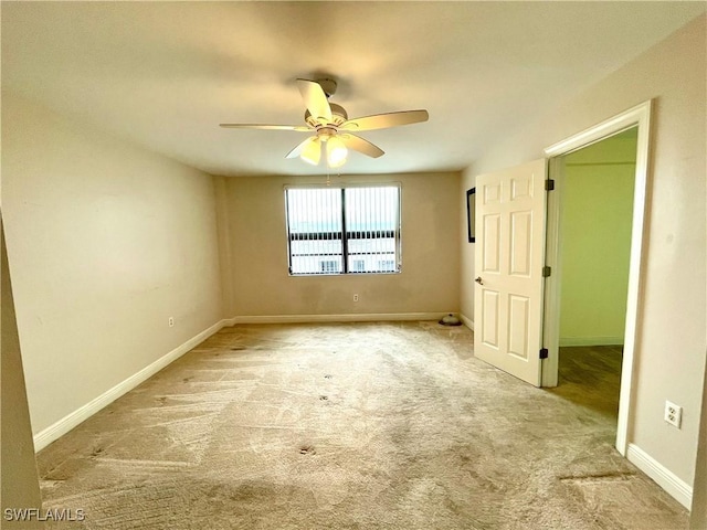 unfurnished bedroom with ceiling fan and light colored carpet