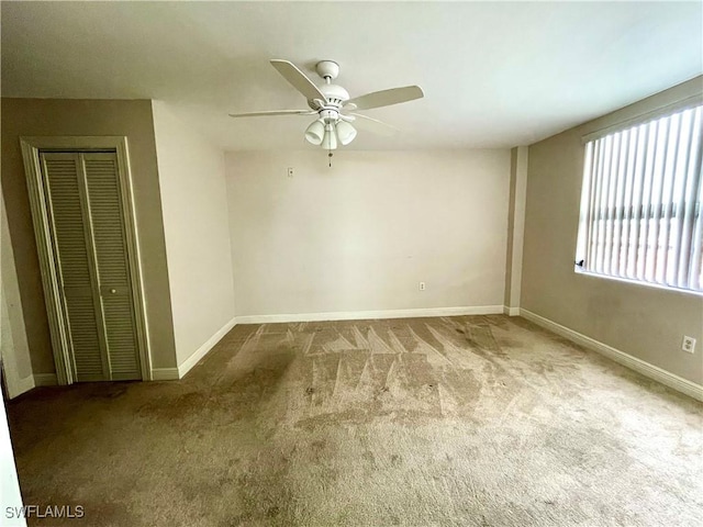 spare room with ceiling fan and carpet flooring