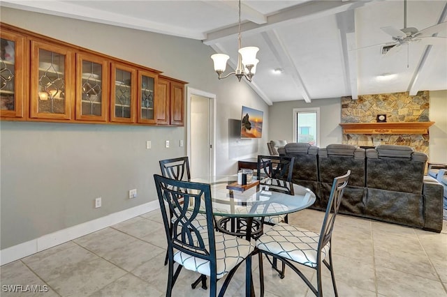 dining area featuring ceiling fan with notable chandelier, a fireplace, light tile patterned flooring, and lofted ceiling with beams