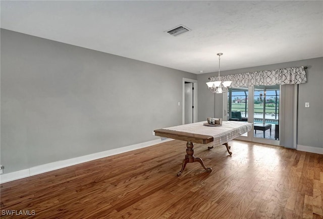 rec room featuring hardwood / wood-style floors and a notable chandelier