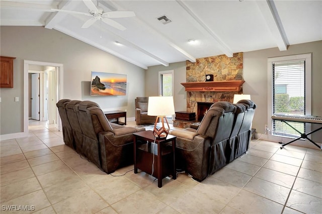 living room with ceiling fan, a stone fireplace, lofted ceiling with beams, and light tile patterned floors