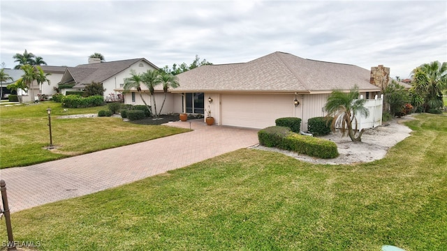 view of front of house featuring a garage and a front lawn