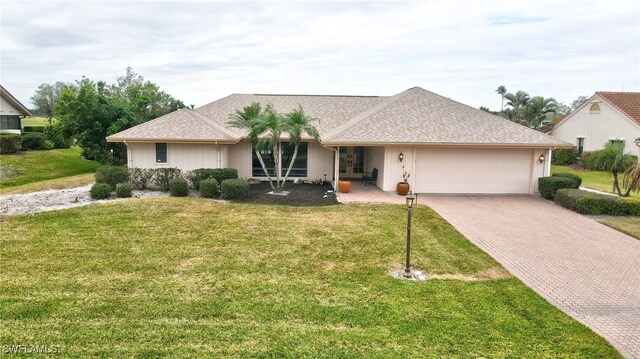 ranch-style home with a garage and a front yard