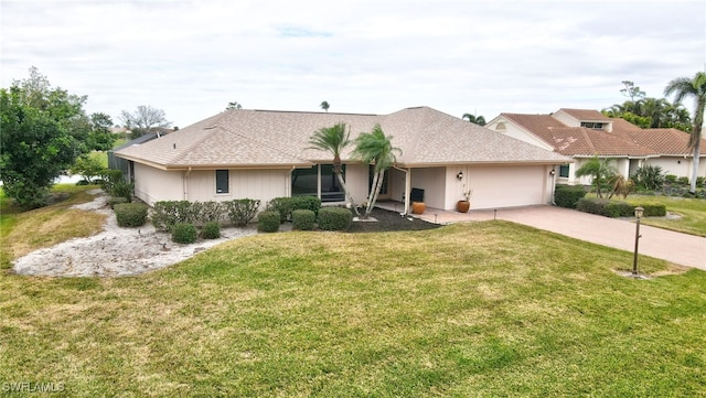 single story home featuring a garage and a front lawn