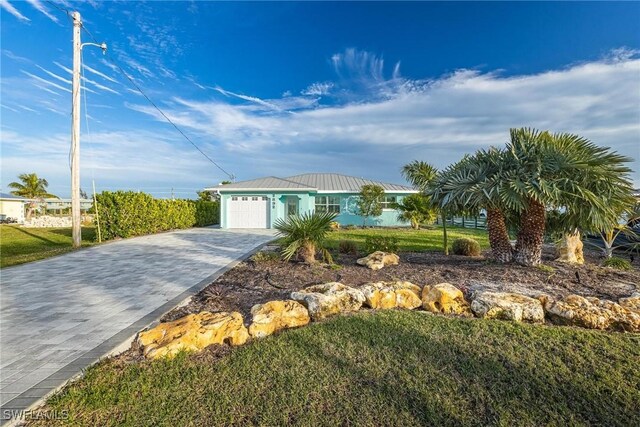 view of front of house with a garage and a front yard