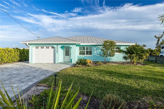 single story home featuring a garage and a front lawn