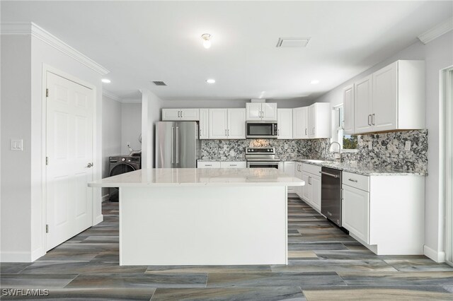 kitchen featuring white cabinetry, appliances with stainless steel finishes, and a kitchen island