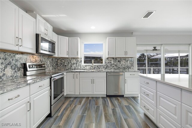 kitchen with white cabinetry, stainless steel appliances, and sink