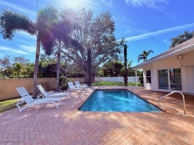 view of swimming pool featuring a fenced in pool, a fenced backyard, and a patio