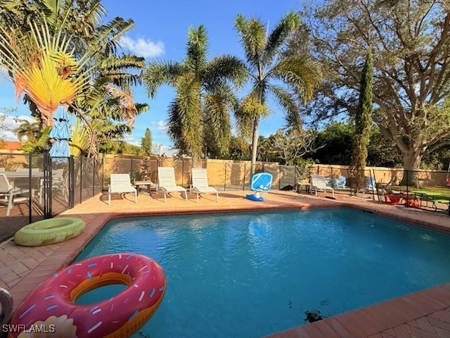 view of pool with fence, a fenced in pool, and a patio