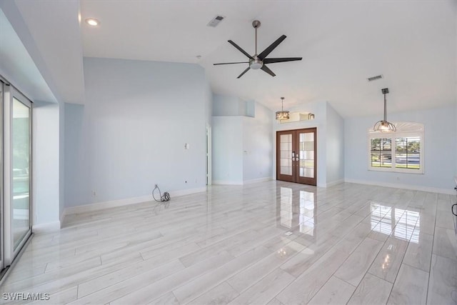 unfurnished living room featuring a ceiling fan, visible vents, baseboards, and french doors