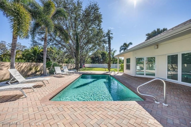 view of pool with a fenced in pool, a fenced backyard, and a patio area