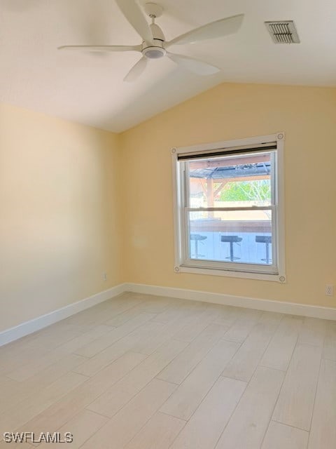 unfurnished room featuring baseboards, visible vents, lofted ceiling, light wood-style floors, and ceiling fan