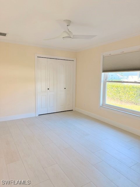 unfurnished bedroom featuring a ceiling fan, visible vents, a closet, and baseboards