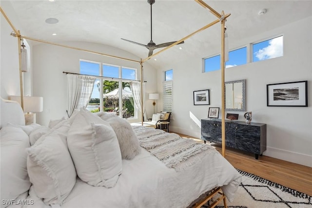 bedroom featuring hardwood / wood-style floors, ceiling fan, and lofted ceiling