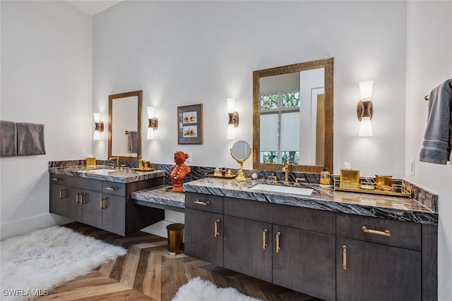 bathroom featuring parquet flooring and vanity