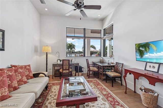 living room with ceiling fan and wood-type flooring