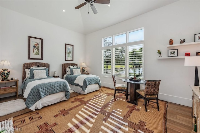 bedroom featuring ceiling fan, wood-type flooring, and vaulted ceiling