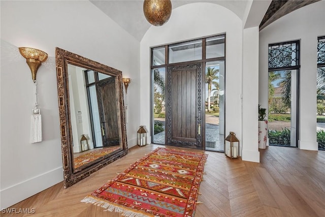 entryway featuring hardwood / wood-style floors and a high ceiling