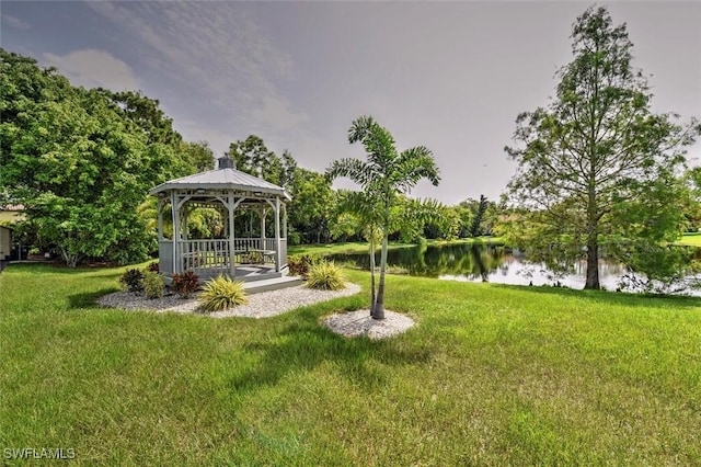 view of yard with a gazebo and a water view