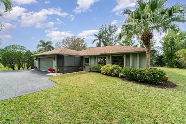 ranch-style home with a front yard and a garage