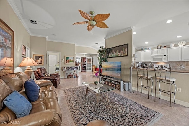 tiled living room featuring vaulted ceiling, ceiling fan, and crown molding