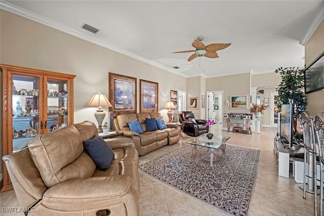 tiled living room with ceiling fan and crown molding