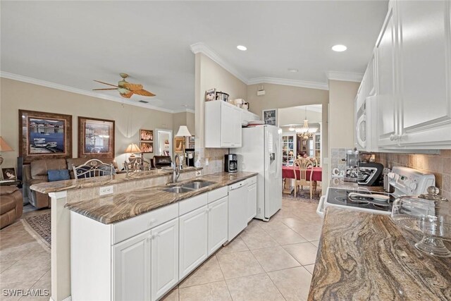 kitchen with tasteful backsplash, kitchen peninsula, white cabinetry, and sink